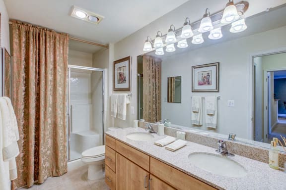 Granite Counter Tops with Full Vanity-Width Mirrors  at The Marque Apartments, Gainesville