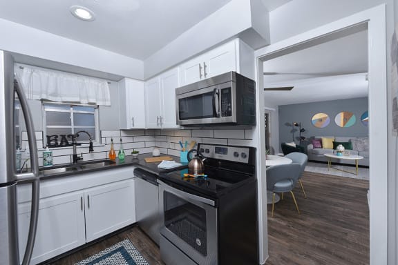 Kitchen in Watermarc apartment in Lakeland, FL with stainless steel dishwasher and white cabinets