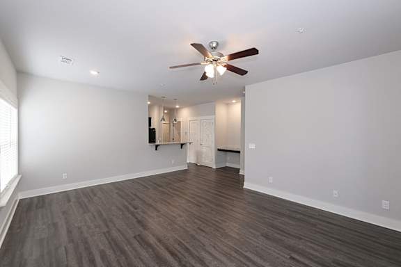 A room with a ceiling fan and wooden flooring at McHenry Square Apartments, Augusta, Georgia