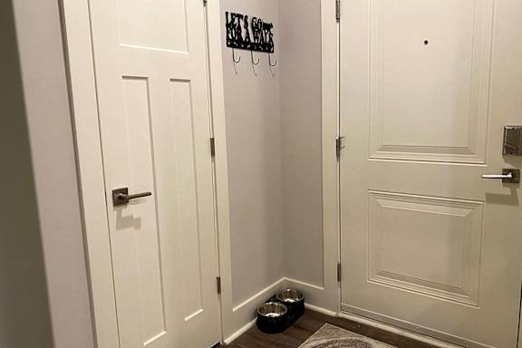 A white door with a black sign that says at McHenry Square Apartments, Augusta, Georgia