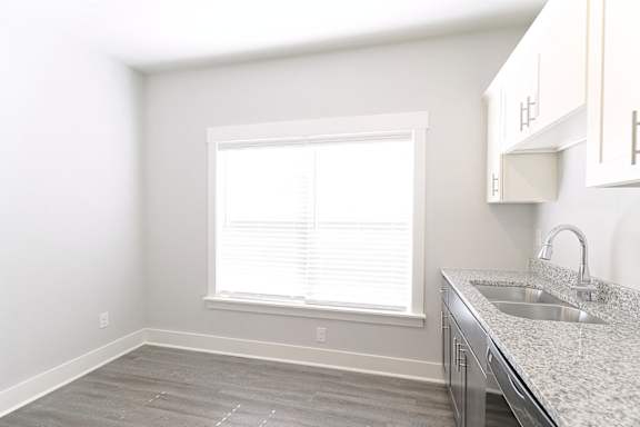 A kitchen with a sink and a window at McHenry Square Apartments, Augusta, GA, 30909