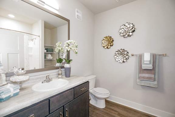 A bathroom with a white sink and a toilet at McHenry Square Apartments, Georgia