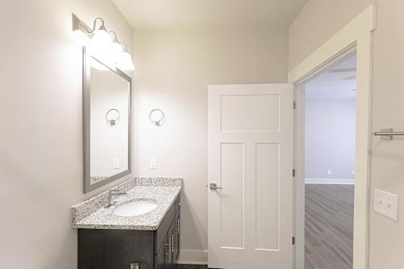 A bathroom with a sink and mirror. at McHenry Square Apartments, Augusta, Georgia