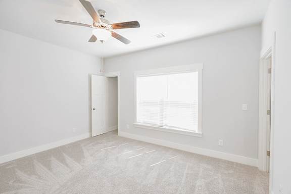 A room with a ceiling fan and a window with blinds at McHenry Square Apartments, Georgia, 30909