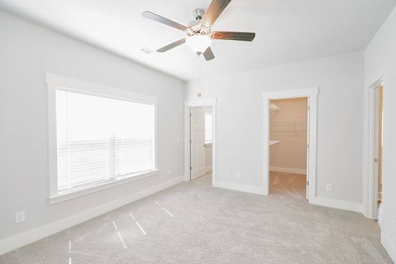 A room with a ceiling fan and carpeted floor at McHenry Square Apartments, Augusta, GA, 30909