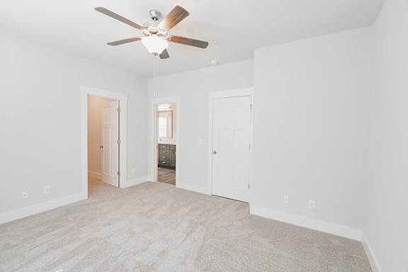 A room with a ceiling fan and carpeted floor at McHenry Square Apartments, Augusta, GA