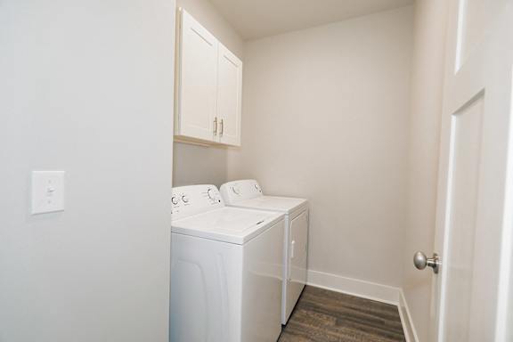 A small laundry room with a washer and dryer at McHenry Square Apartments, Georgia, 30909
