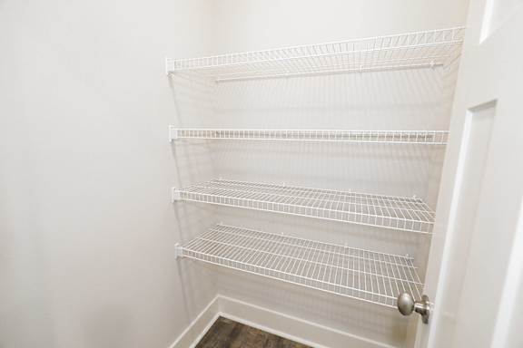 Empty white shelves in a white closet at McHenry Square Apartments, Augusta, GA, 30909
