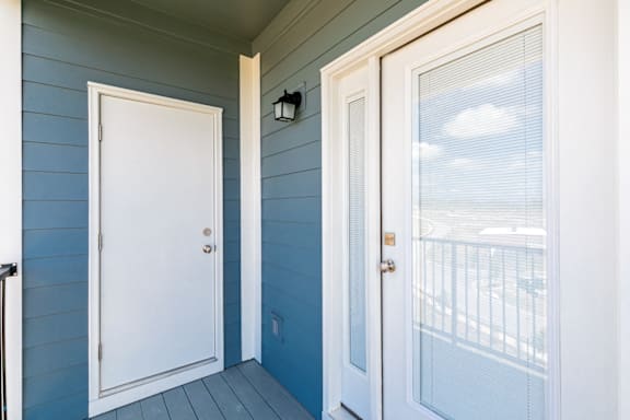 A white door is on the left and a glass door is on the right at McHenry Square Apartments, Augusta, GA