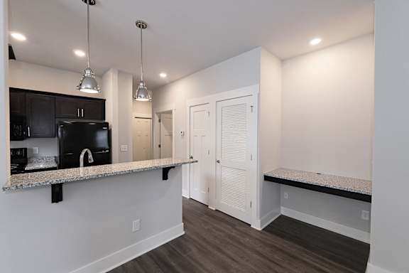A kitchen area with a microwave and a counter at McHenry Square Apartments, Georgia