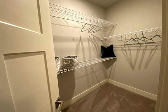 A white closet with a pillow on a shelf at McHenry Square Apartments, Georgia