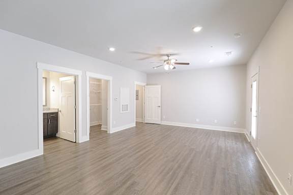 A room with a ceiling fan and lighting fixtures at McHenry Square Apartments, Augusta, GA