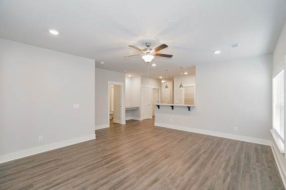 A spacious room with a ceiling fan and lighting fixtures at McHenry Square Apartments, Augusta, GA, 30909