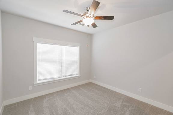A room with a ceiling fan and a window with blinds at McHenry Square Apartments, Augusta, GA