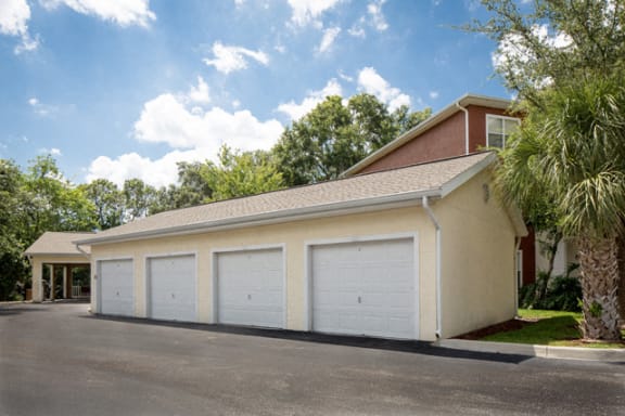 Four car garages with white doors at The Arbor Walk Apartments, Florida, 33617