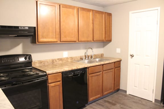 Wooden cabinets and black appliances at Quail Meadow Apartments, Cincinnati, OH, 45240