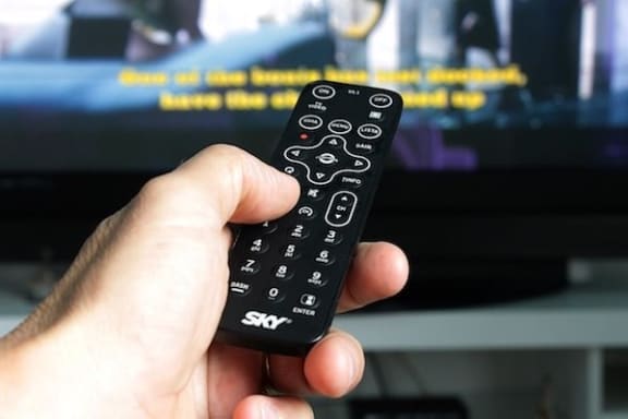 hand pointing remote at tv