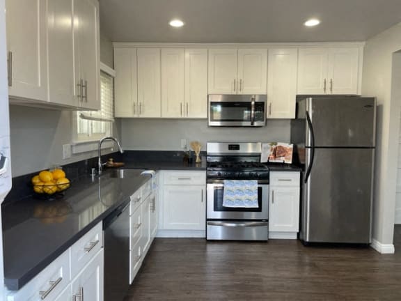 a kitchen with stainless steel appliances and white cabinets