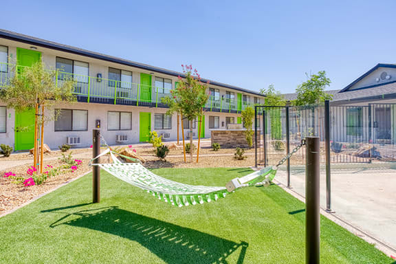 Hammock lounge on green turf at Fusion Las Vegas apartments in