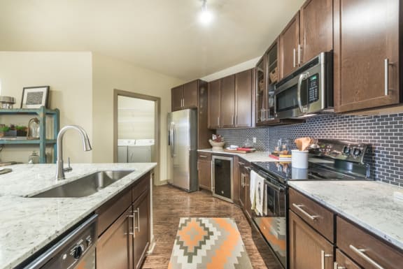 Fitted Kitchen With Island Dining at Aviator West 7th, Texas