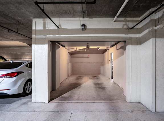 Underground parking garage with covered parking spaces at Nalle Woods of Westlake Apartments, Austin, Texas