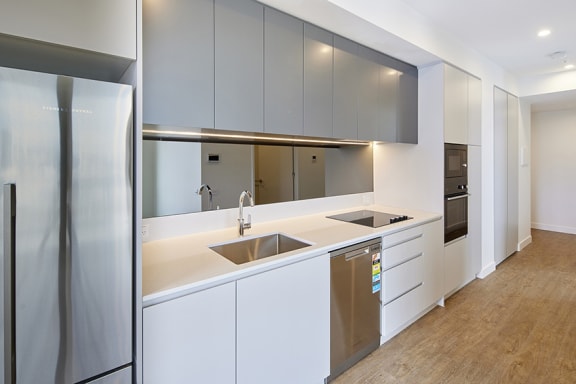 a modern kitchen with cabinets and stainless steel appliances