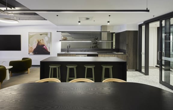 a large black kitchen with a table and chairs