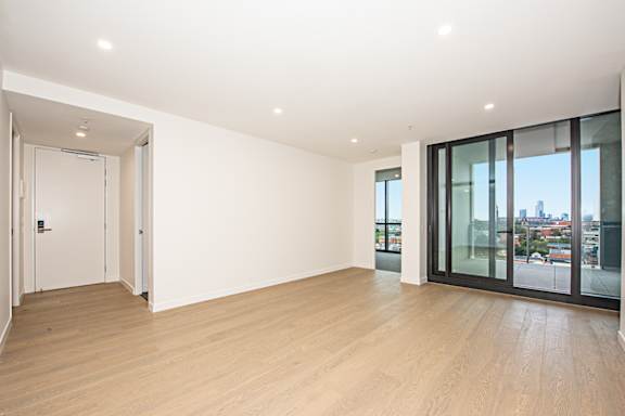 A room with wooden floors and white walls.