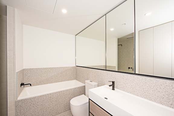 A white bathroom with a toilet, sink, and bathtub.