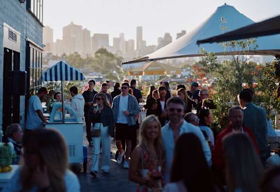 A group of people are gathered at an outdoor event.