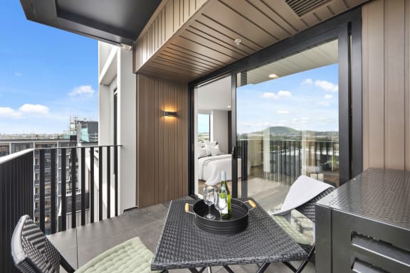 a view of a balcony with a table and chairs
