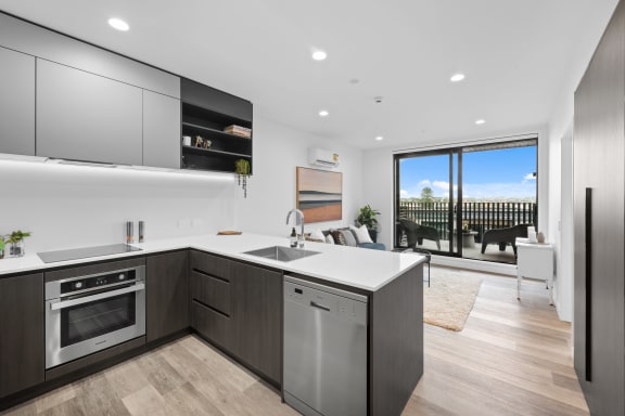 a kitchen with a white counter top and a sink