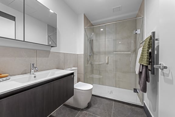 a bathroom with a toilet sink and shower