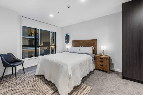 a bedroom with a large bed and a window