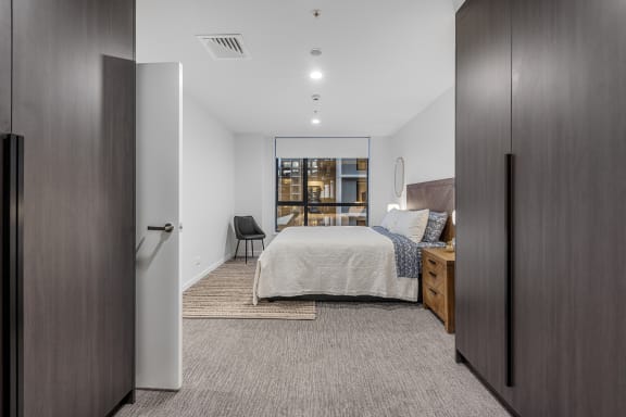a bedroom with a large bed and a window