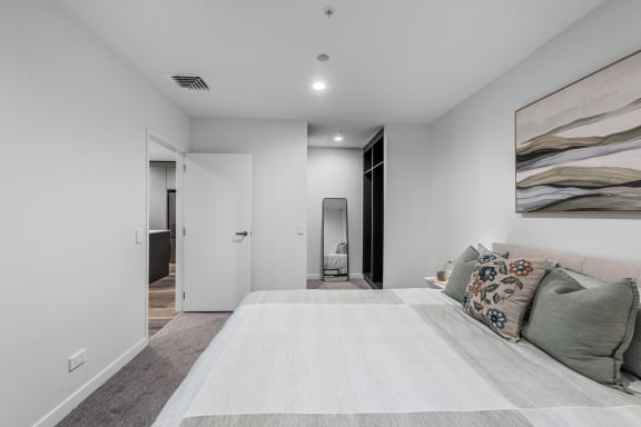 a bedroom with a bed and a door to a bathroom
