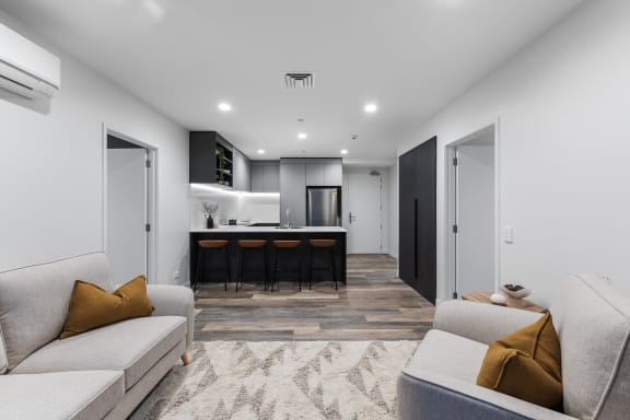 a living room with a couch and a kitchen