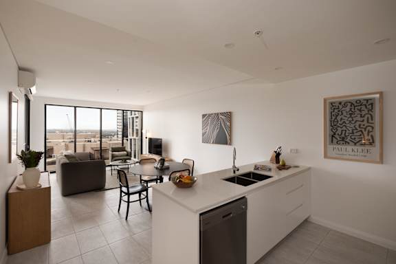 A kitchen with a dining table and chairs in the middle of the room.