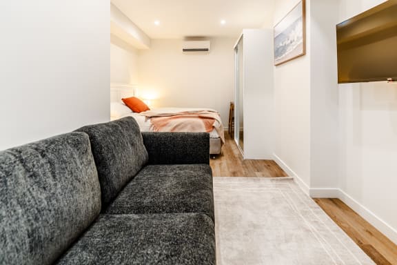 a living room with a couch and a bed