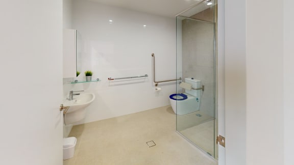 a bathroom with a toilet and a sink and a shower