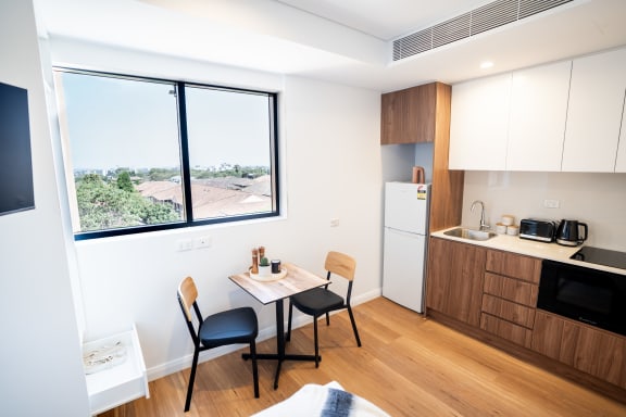 a small kitchen and dining room with a large window