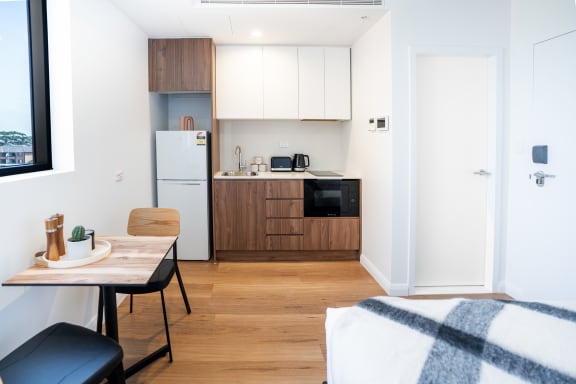 a small apartment with a kitchen and a dining room