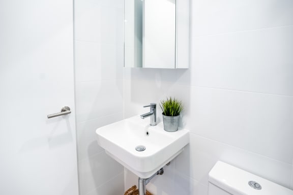 a white bathroom with a sink and a mirror