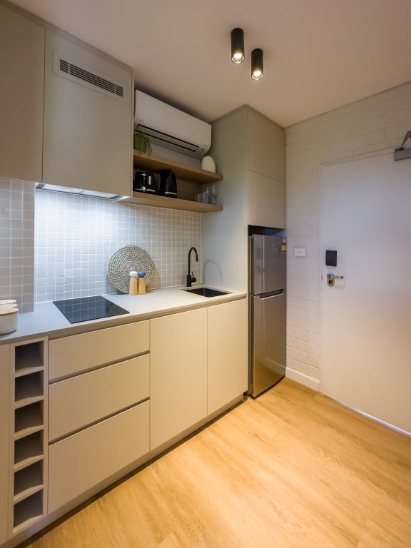 a kitchen with white cabinets and a stainless steel refrigerator