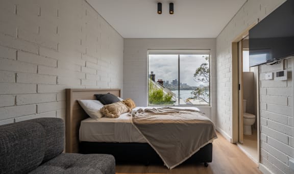 a bedroom with a bed and a window with a view
