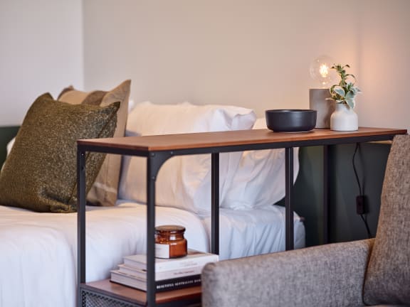 a bed with a wooden table on top of it