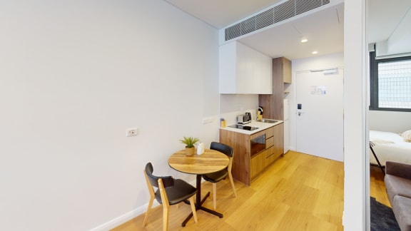 a kitchen and dining area with a table and chairs