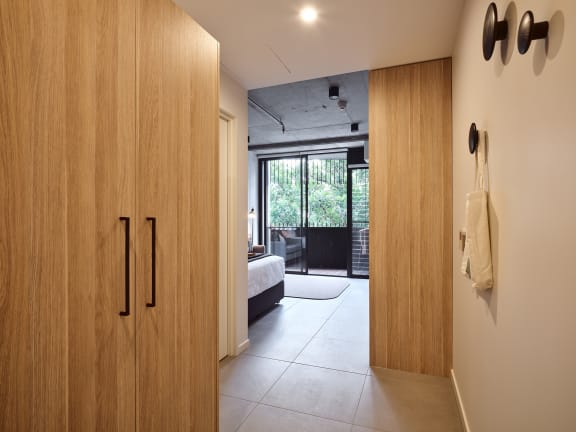 a hotel room with a bed and a door to a bathroom