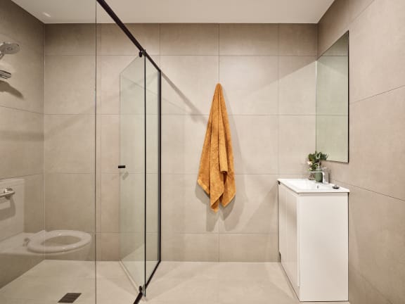 a bathroom with a shower and a towel hanging on the wall