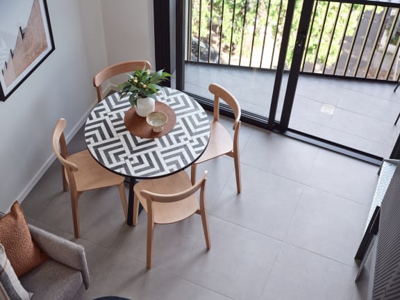 a dining room with a table with a plant on it